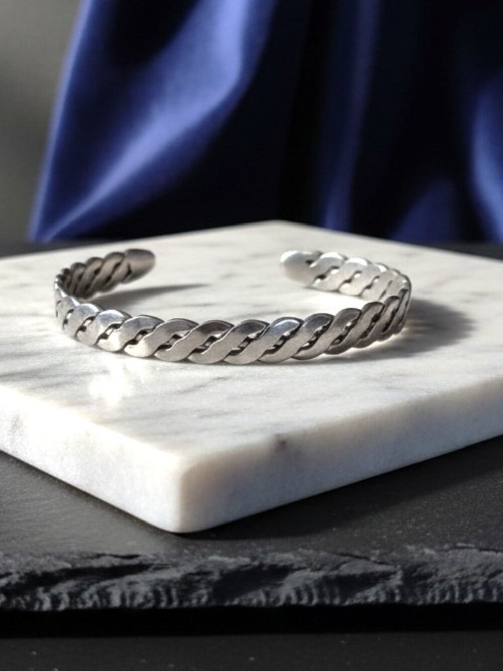 1990's A silver-tone open cuff bracelet with a braided design. SHIPS FREE